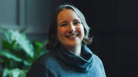 Panaseer Leila Powell, former astrophysicist, smiling. 